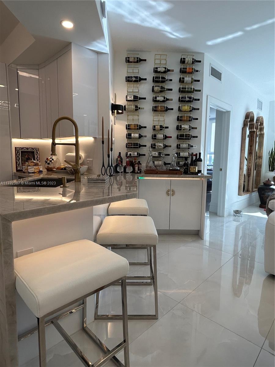 888 Brickell Key Drive, Unit 802 Miami, FL 33131 - Photo 36 of 42 a kitchen with a table chairs and a stove