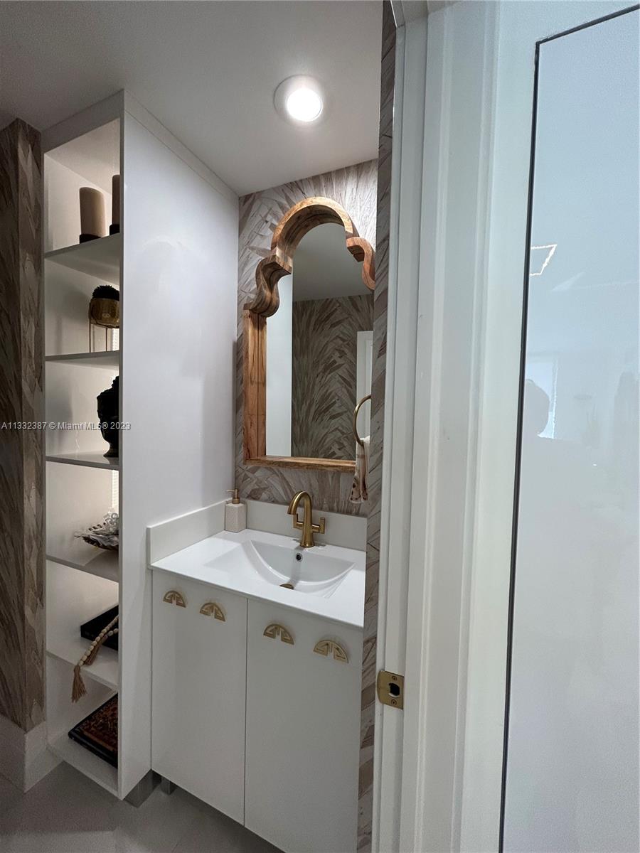 888 Brickell Key Drive, Unit 802 Miami, FL 33131 - Photo 39 of 42 a bathroom with a sink and a mirror