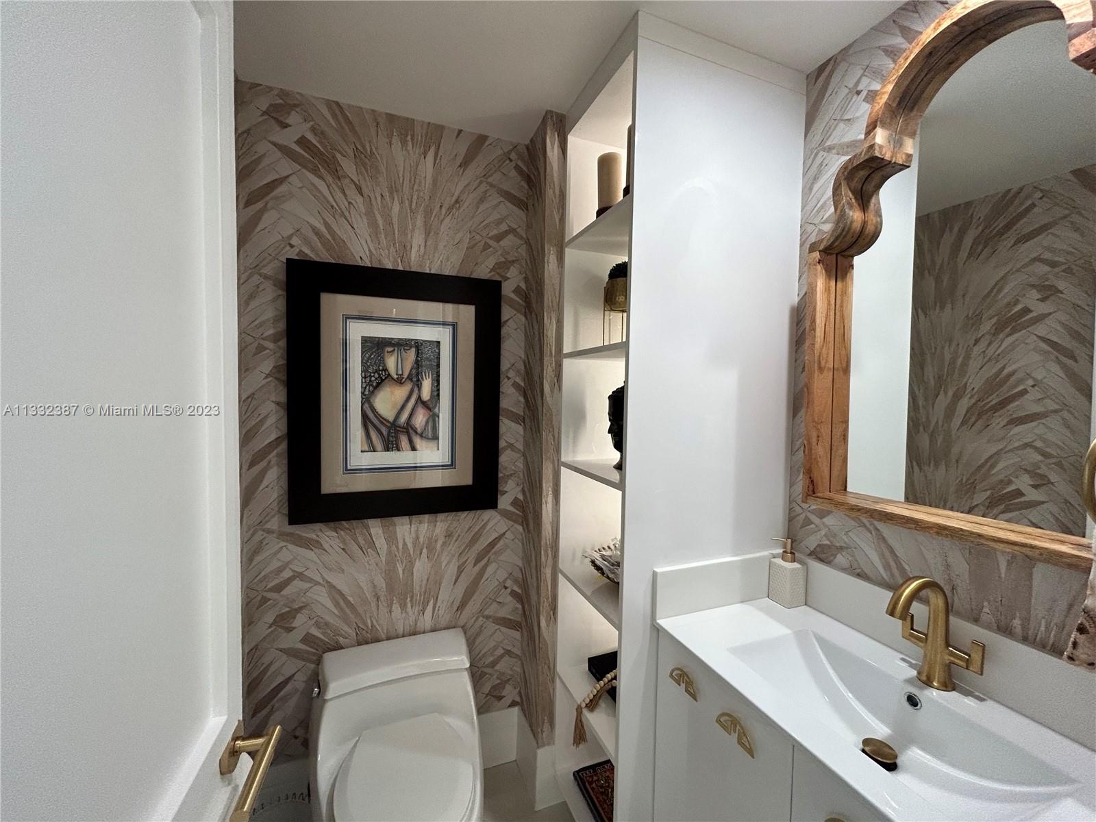 888 Brickell Key Drive, Unit 802 Miami, FL 33131 - Photo 40 of 42 a bathroom with a toilet and a sink