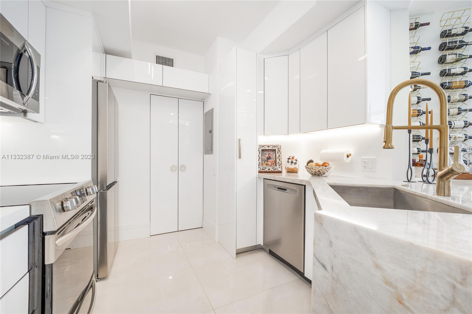 888 Brickell Key Drive, Unit 802 Miami, FL 33131 - Photo 4 of 42 a kitchen with a refrigerator sink and white cabinets
