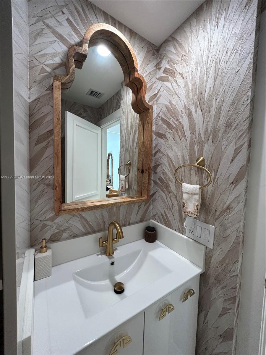 888 Brickell Key Drive, Unit 802 Miami, FL 33131 - Photo 41 of 42 a bathroom with a sink and a mirror