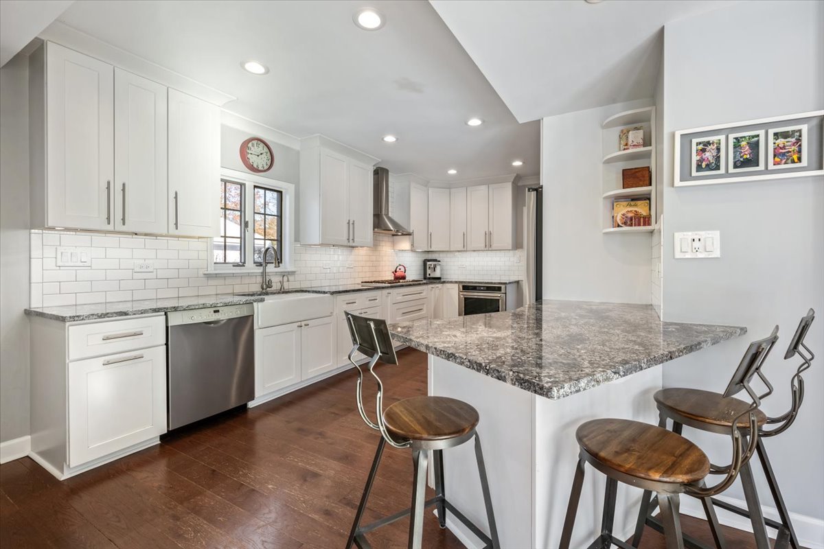 909 Locust Road Wilmette, IL 60091 - Photo 14 of 45 a kitchen with cabinets and chairs