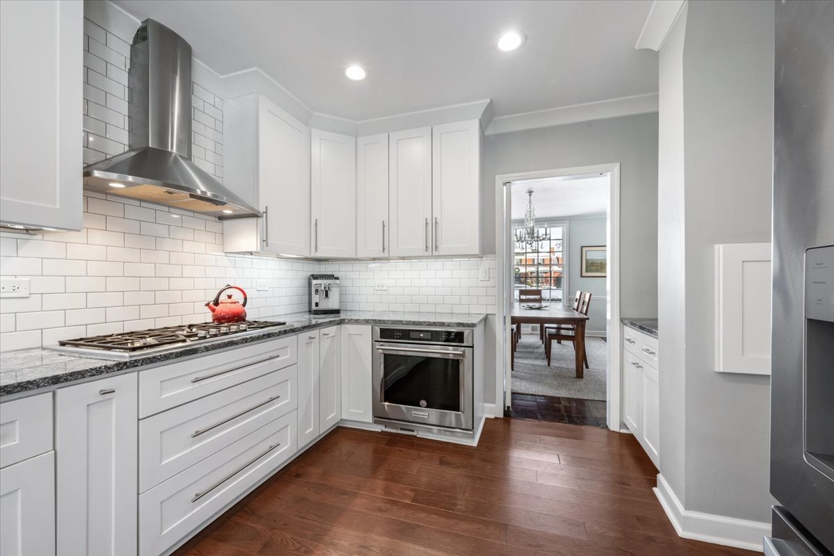 909 Locust Road Wilmette, IL 60091 - Photo 16 of 45 a kitchen with granite countertop stainless steel appliances and wooden cabinets