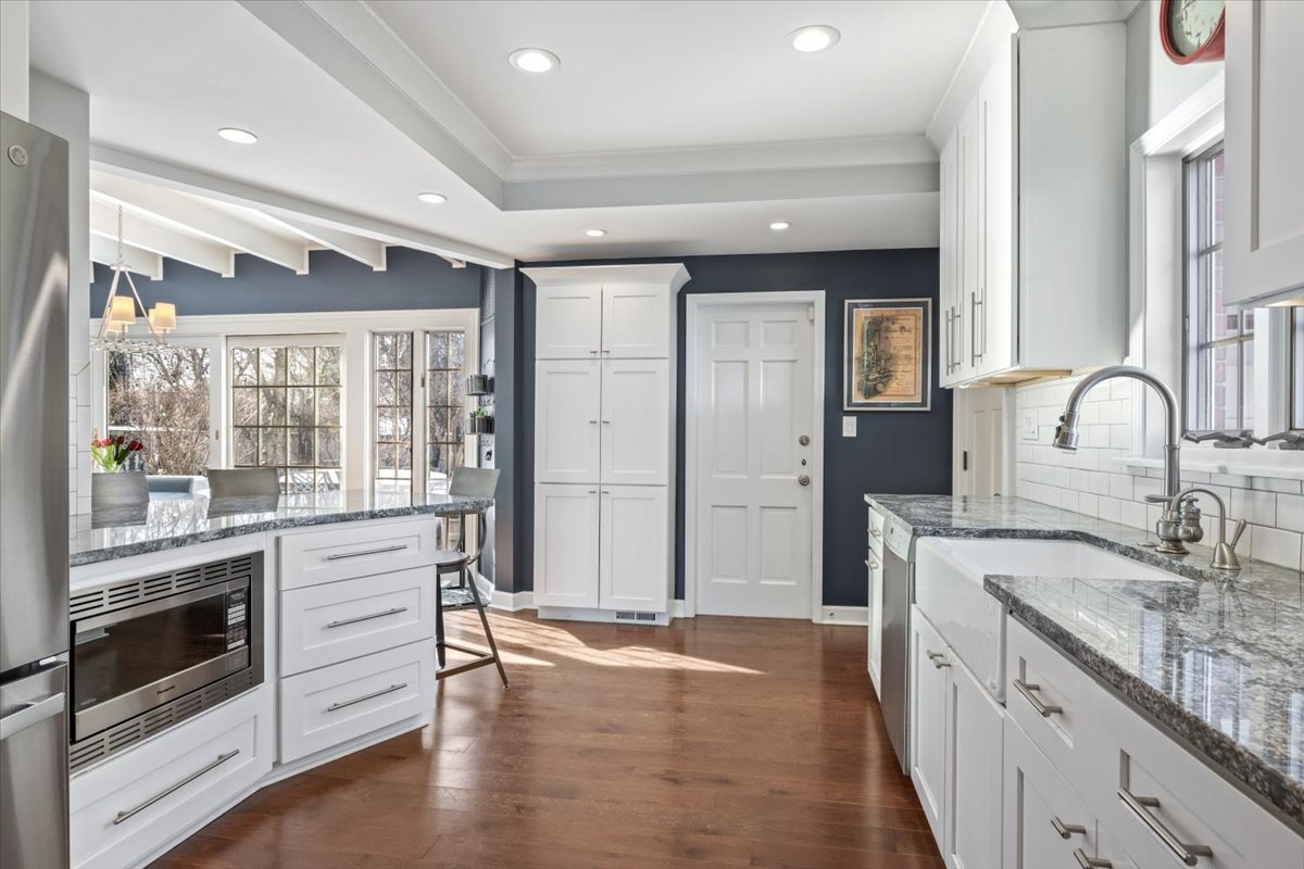 909 Locust Road Wilmette, IL 60091 - Photo 17 of 45 a kitchen with stainless steel appliances granite countertop a stove and a sink