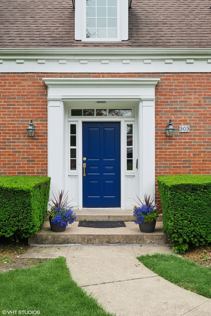 909 Locust Road Wilmette, IL 60091 - Photo 2 of 45 a front view of a house with a yard and garage