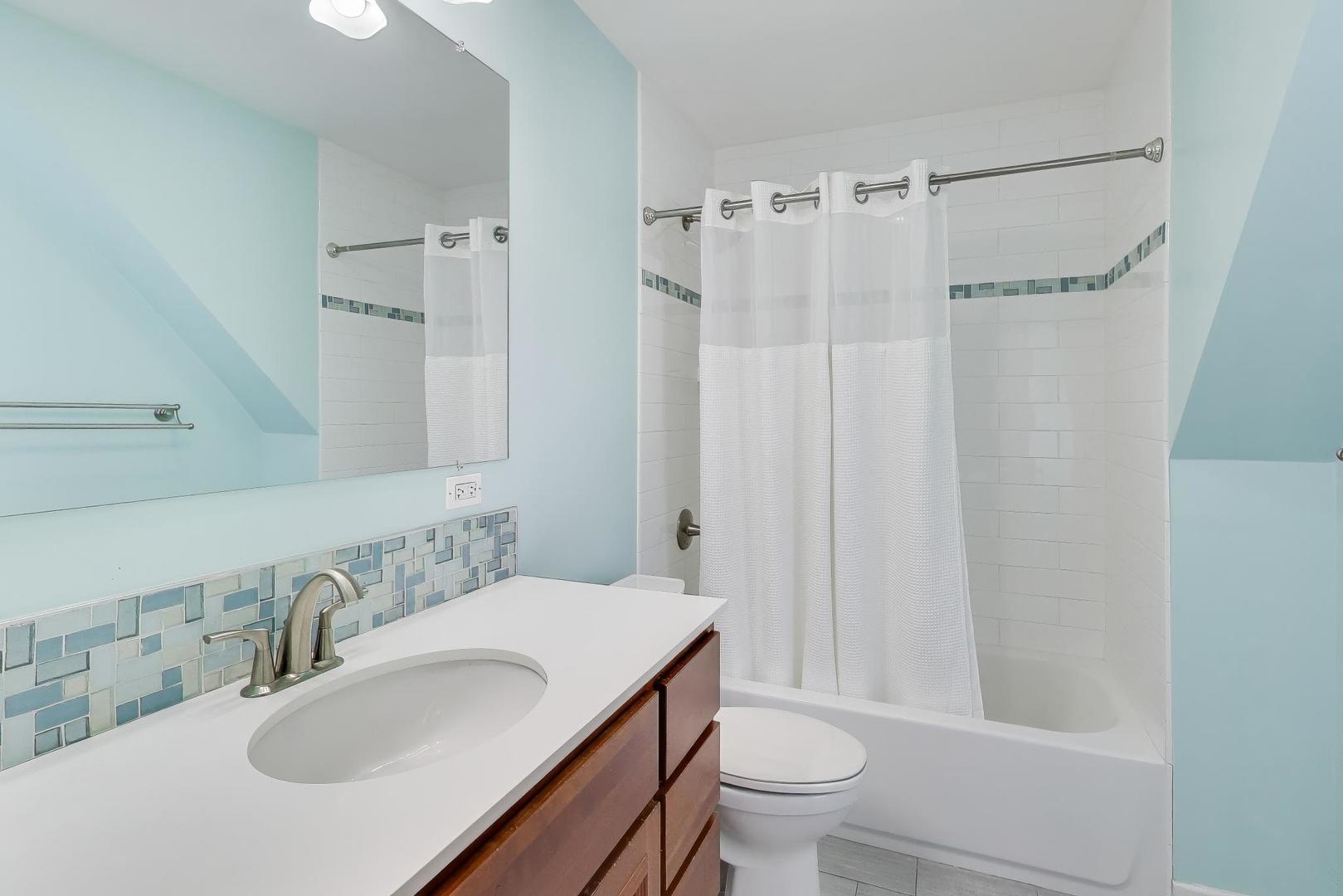 909 Locust Road Wilmette, IL 60091 - Photo 28 of 45 a bathroom with a sink toilet and shower