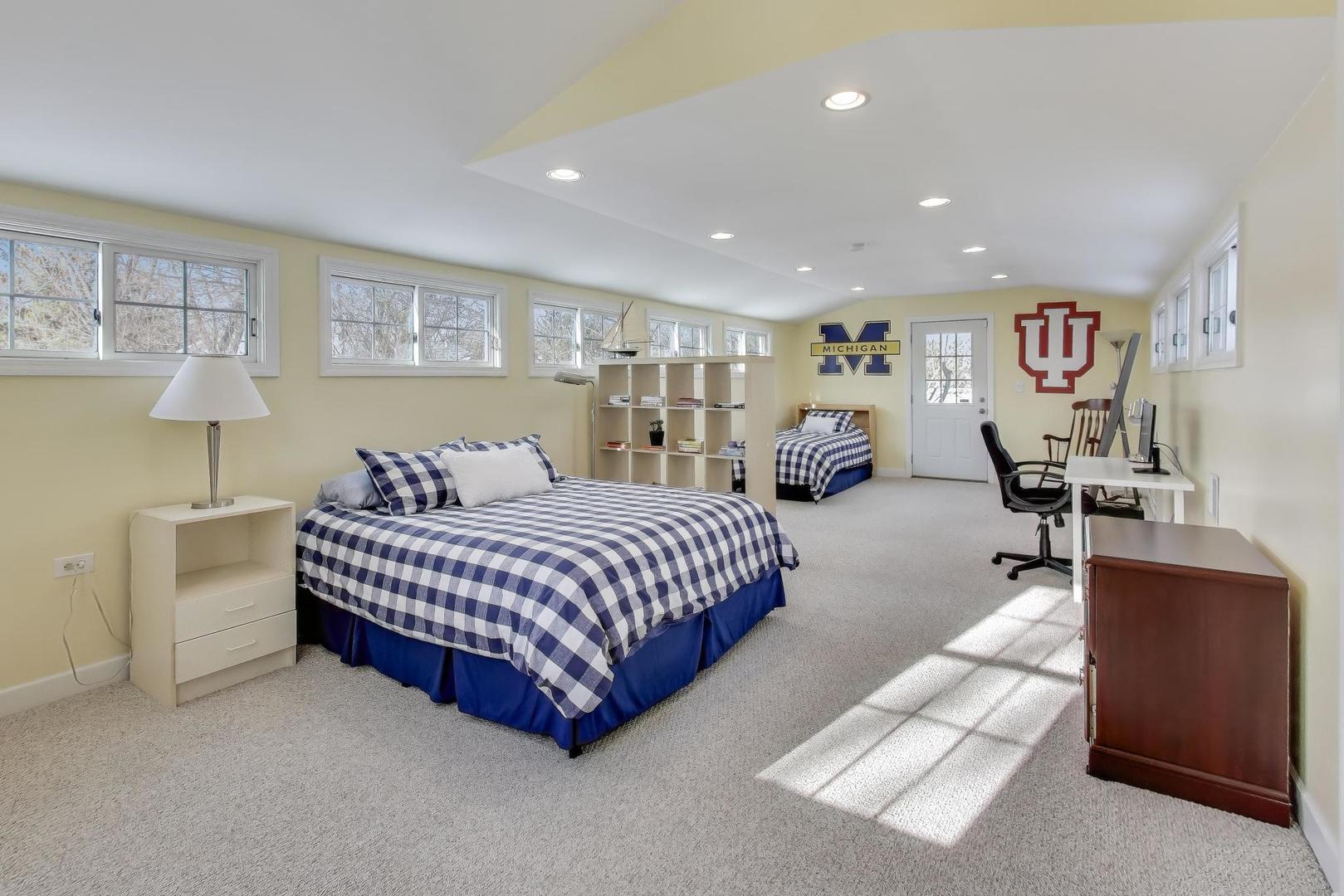 909 Locust Road Wilmette, IL 60091 - Photo 30 of 45 a spacious bedroom with a bed and furniture