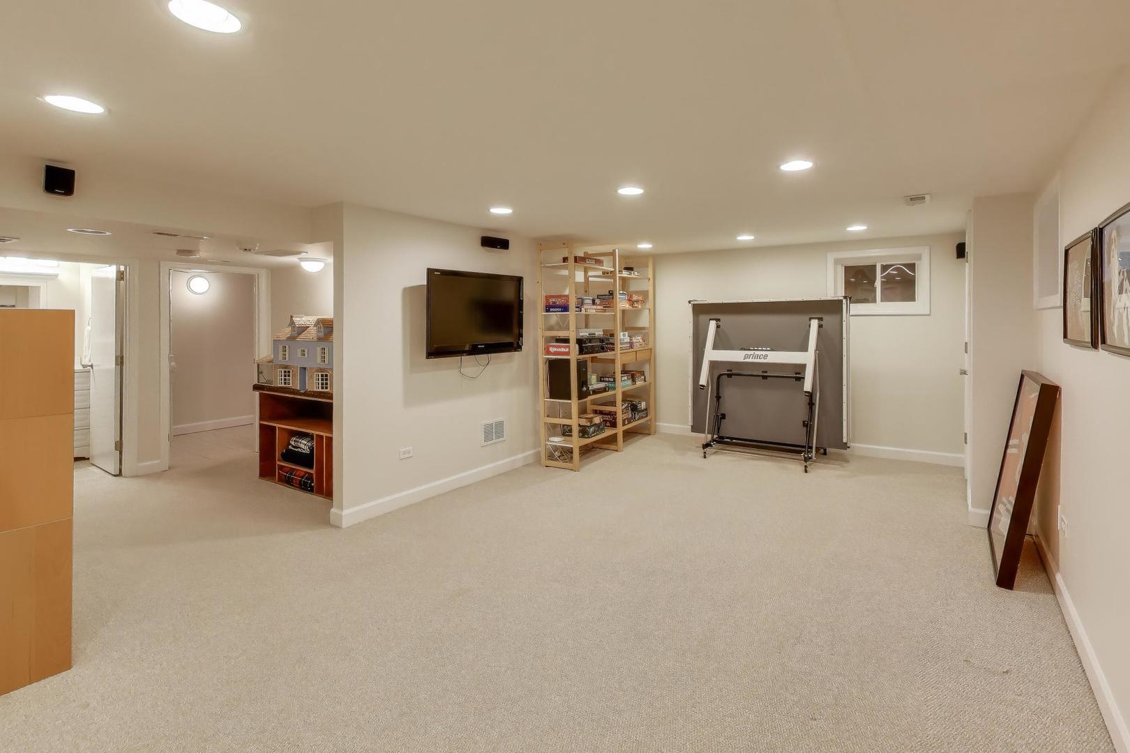 909 Locust Road Wilmette, IL 60091 - Photo 33 of 45 a living room with furniture and a flat screen tv