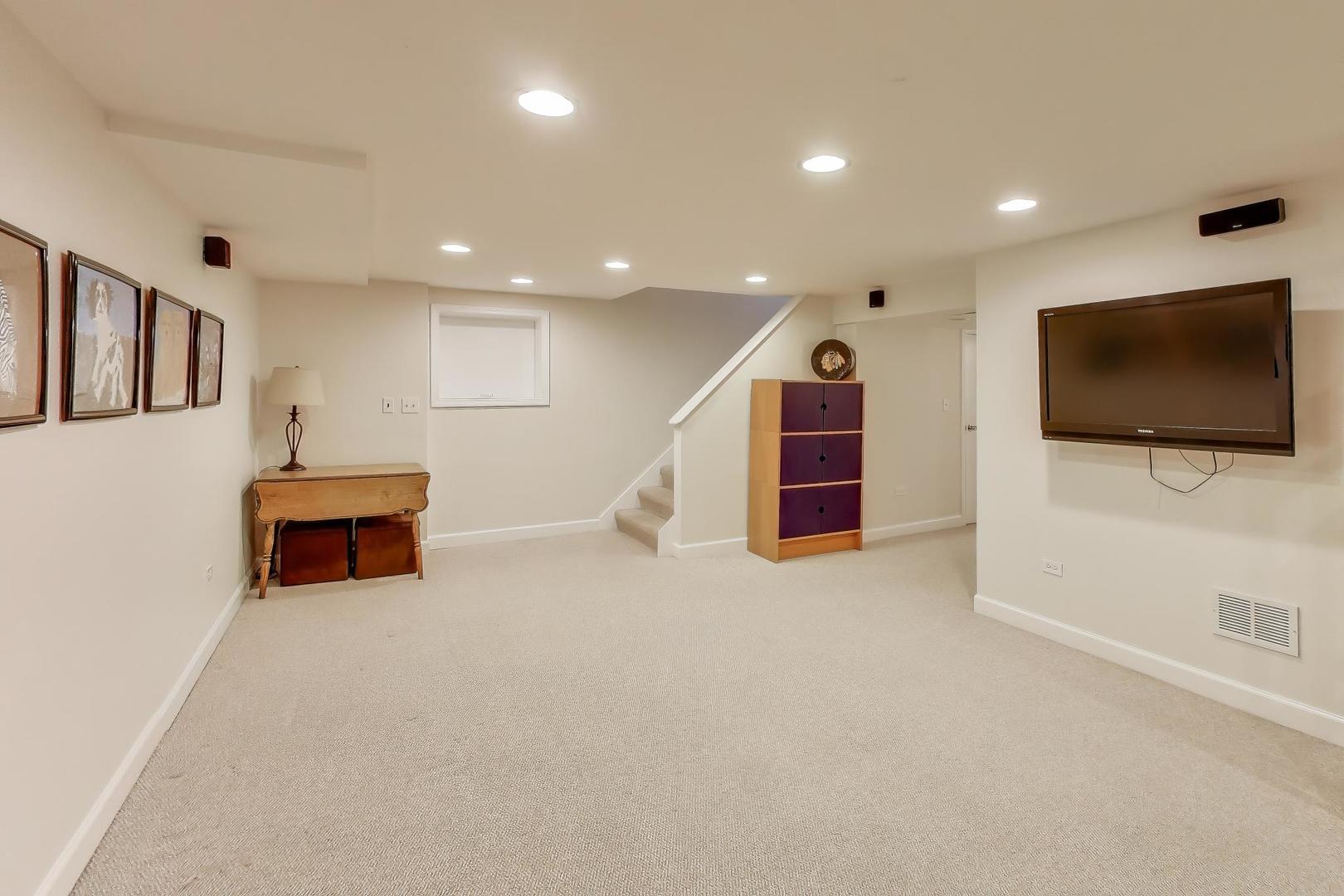 909 Locust Road Wilmette, IL 60091 - Photo 34 of 45 a living room with furniture and a flat screen tv