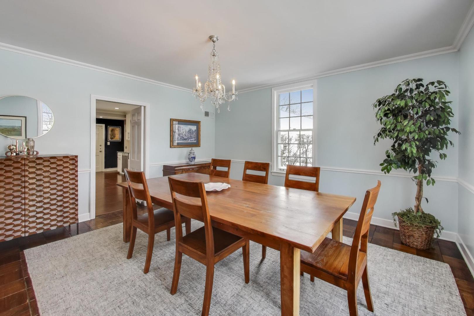 909 Locust Road Wilmette, IL 60091 - Photo 6 of 45 a view of a dining room with furniture and wooden floor