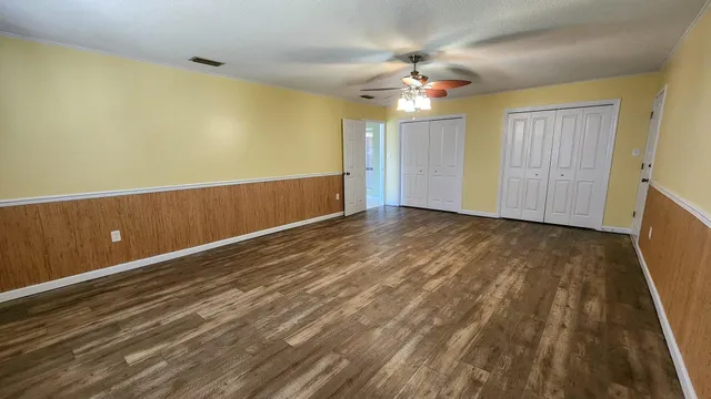 a view of an empty room with a bathroom