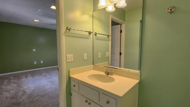 an empty room with closet and chandelier fan