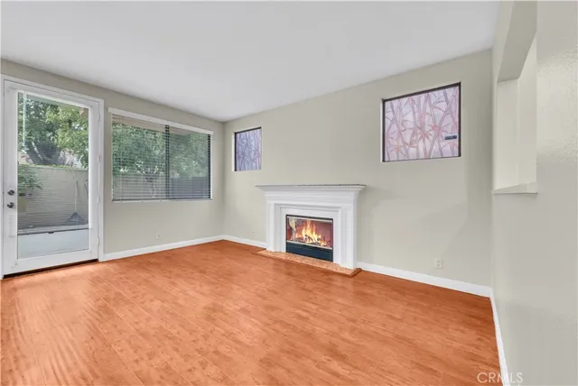 a view of empty room with window and fireplace