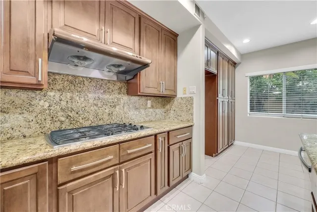 a kitchen with stainless steel appliances granite countertop a sink and cabinets