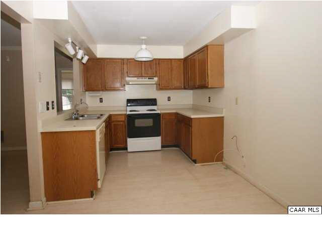 381 Minor Ridge Road Charlottesville, VA 22901 - Photo 3 of 13 a kitchen with stainless steel appliances a sink a stove a refrigerator cabinets and a window