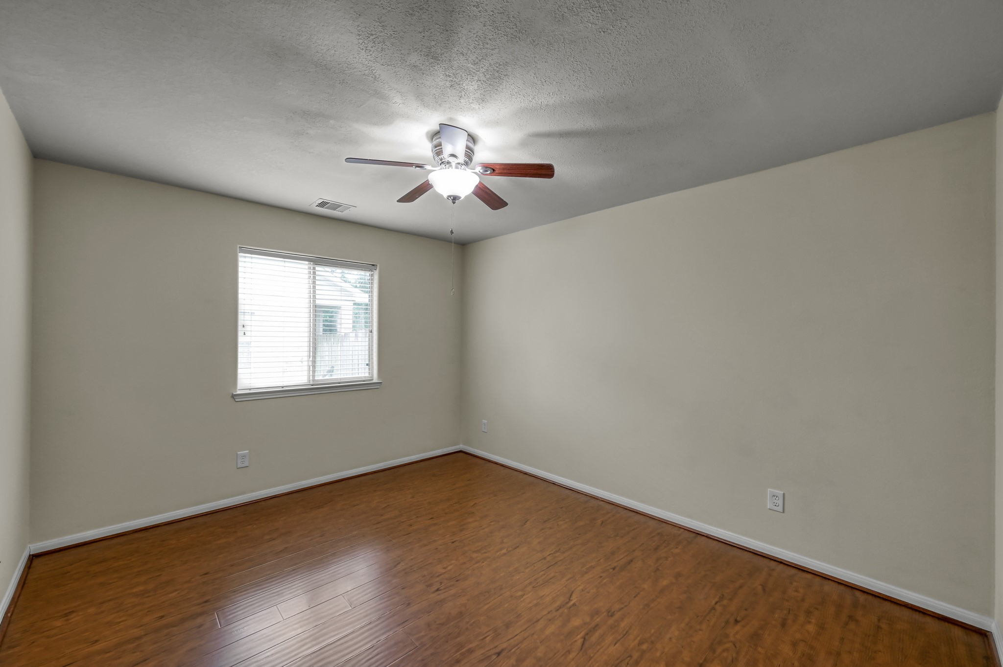 631 Timberstand Lane Spring, TX 77373 - Photo 29 of 38 This spacious secondary bedroom features laminate flooring, a ceiling fan, and a versatile layout perfect for guests or a home office.