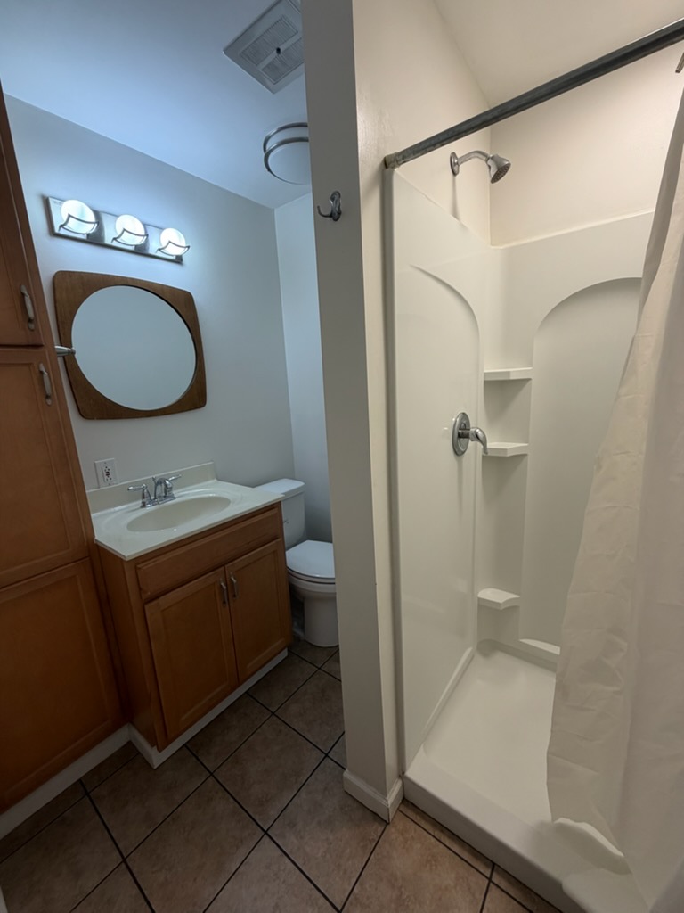 4924 Bayside Drive Riverside, OH 45431 - Photo 20 of 21 This bathroom features a shower, sink, and toilet, offering a compact and functional space.
