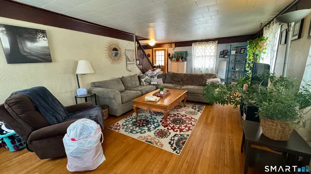 a living room with furniture and flowers
