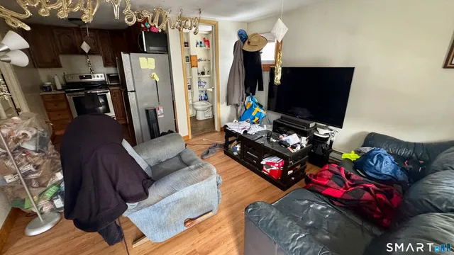 a living room with furniture a flat screen tv and a couch