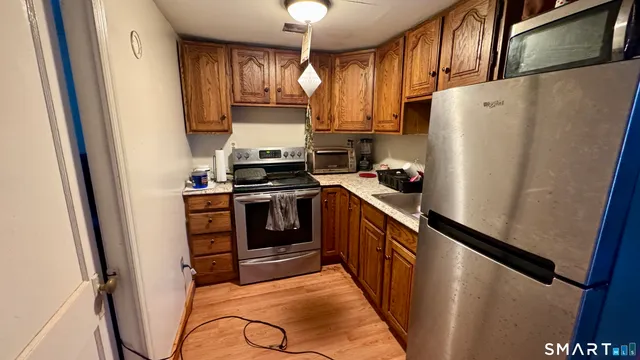a kitchen with stainless steel appliances a refrigerator and a stove top oven