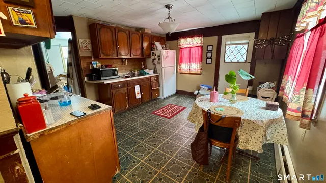 a kitchen that has a lot of furniture and window