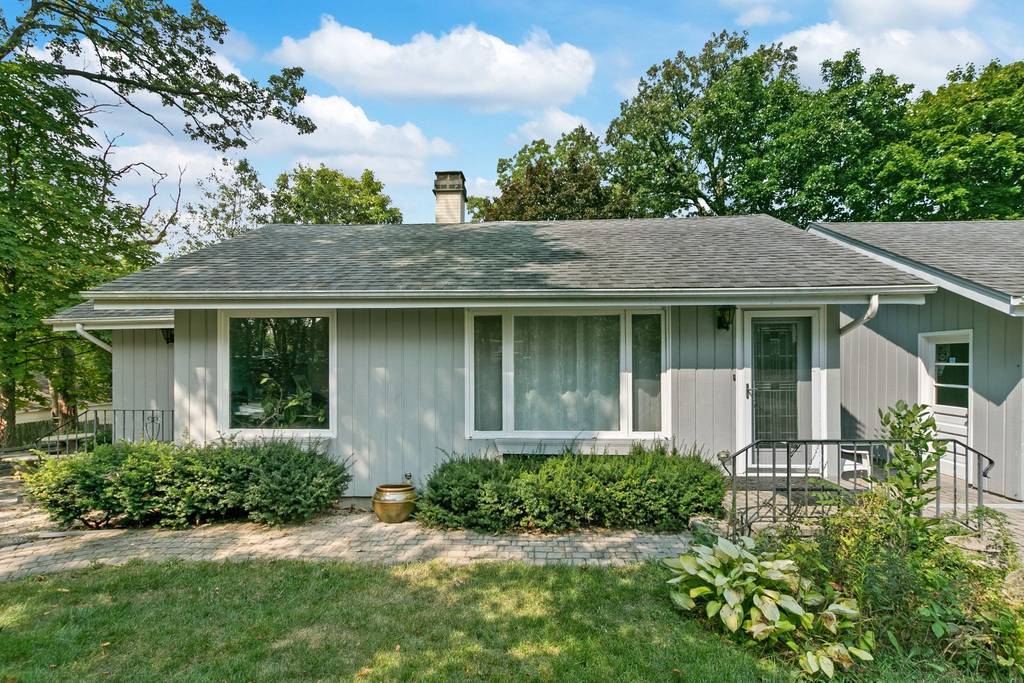 905 Ridge Avenue Wauconda, IL 60084 - Photo 1 of 27 a front view of a house with a garden and plants