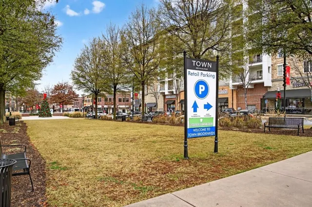 a street sign on a sidewalk next to a road