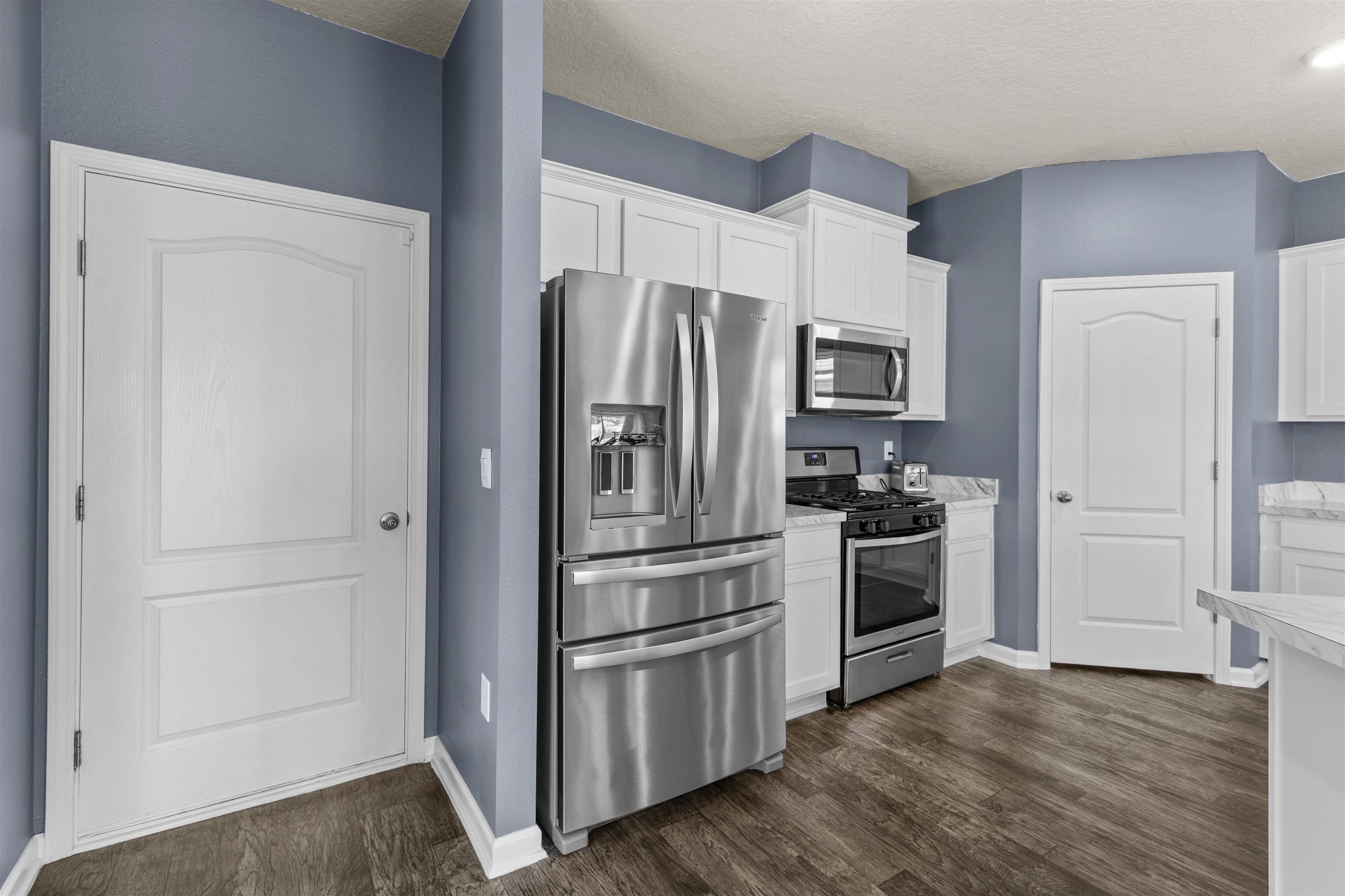 266 Caminha Road St. Augustine, FL 32084 - Photo 23 of 59 a kitchen with a refrigerator stove and wooden floor