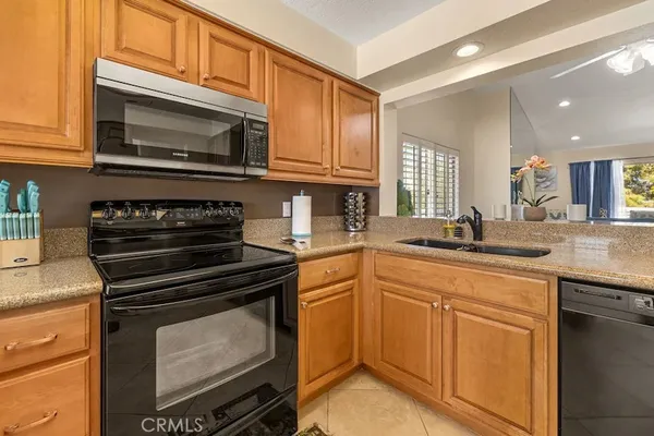 a kitchen with stainless steel appliances granite countertop a stove microwave and sink
