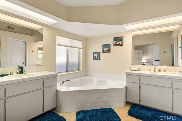 a bathroom with a tub sink and mirror
