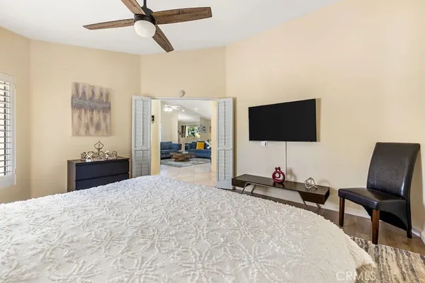 a bedroom with a bed and a flat screen tv