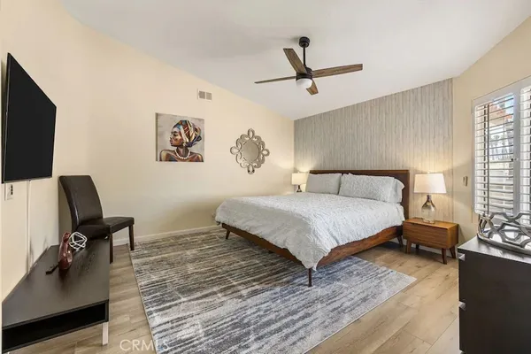 a bedroom with a bed and a chair