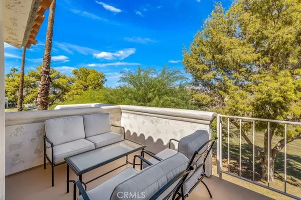 a balcony with wooden floor and outdoor space