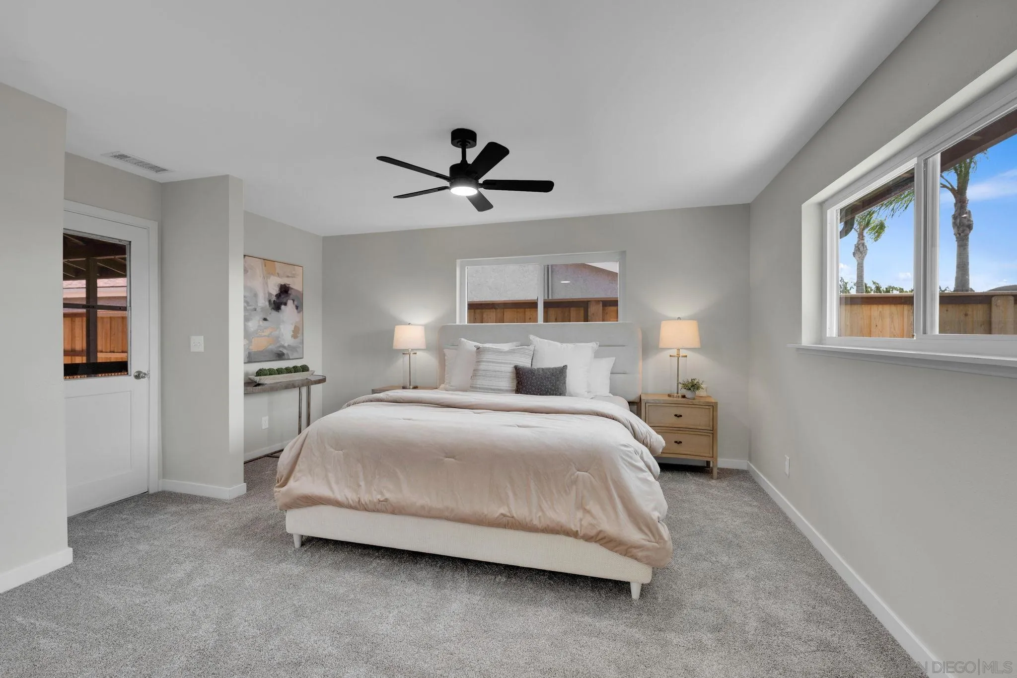 13322 Via Mark Poway, CA 92064 - Photo 11 of 25 a spacious bedroom with a bed a ceiling fan and a large window