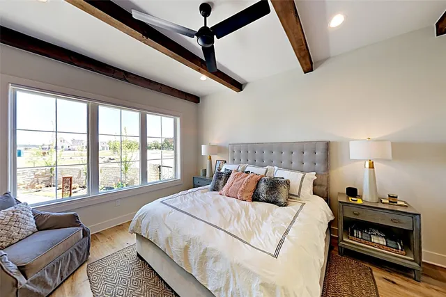 a bedroom with a bed and a large window