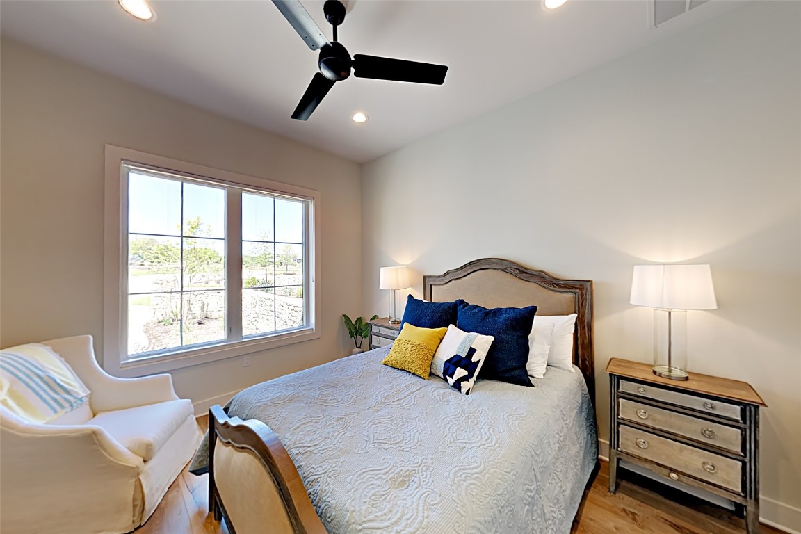 19517 Flying J Boulevard, Unit 6 Spicewood, TX 78669 - Photo 16 of 32 a bedroom with a bed and a large window