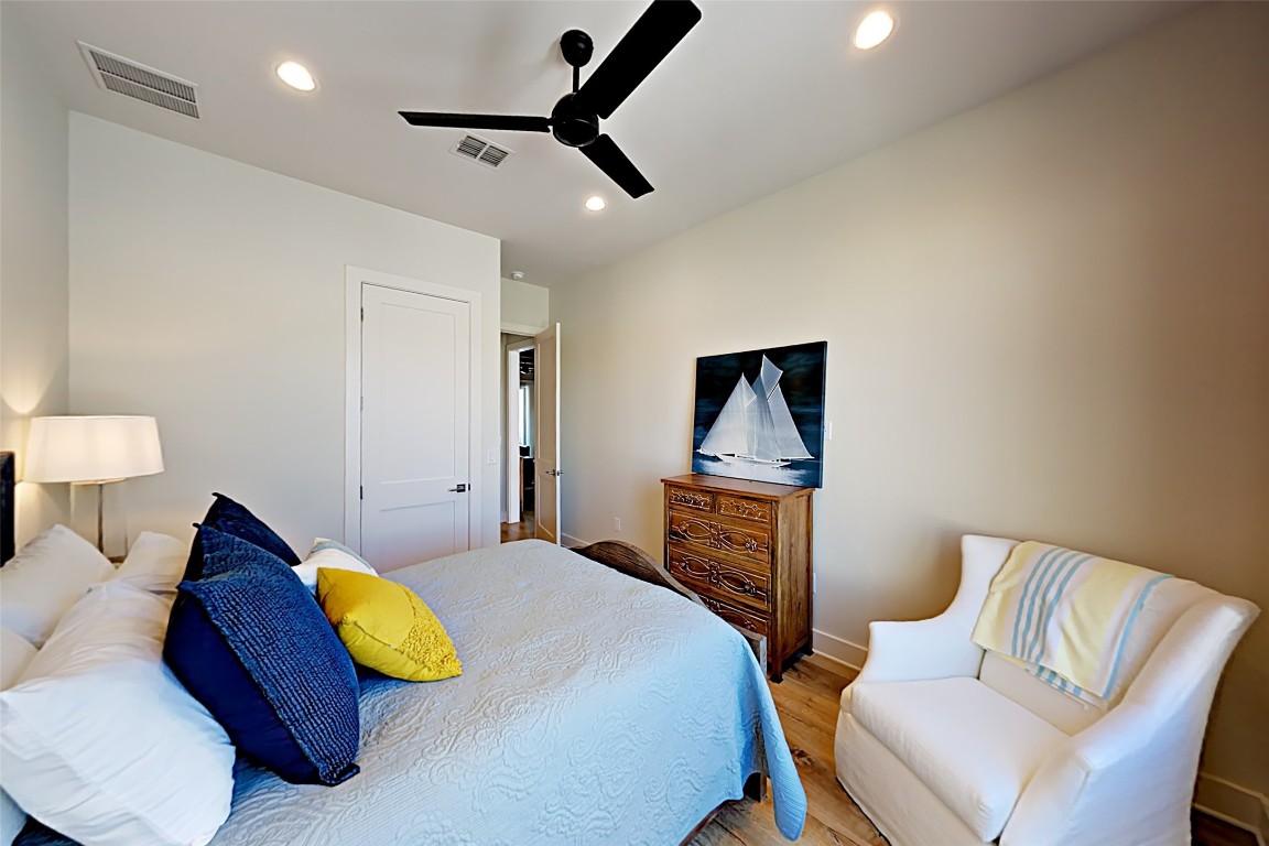 19517 Flying J Boulevard, Unit 6 Spicewood, TX 78669 - Photo 17 of 32 a bed room with a bed and a couch