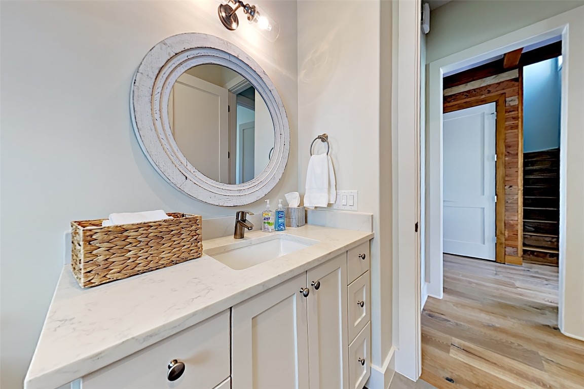 19517 Flying J Boulevard, Unit 6 Spicewood, TX 78669 - Photo 18 of 32 a bathroom with a sink and a mirror