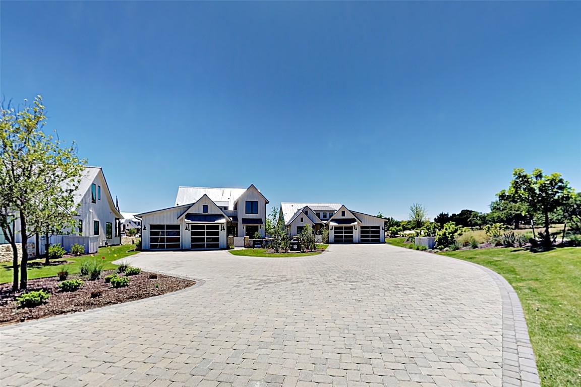 19517 Flying J Boulevard, Unit 6 Spicewood, TX 78669 - Photo 2 of 32 a view of a house with outdoor space and sitting area