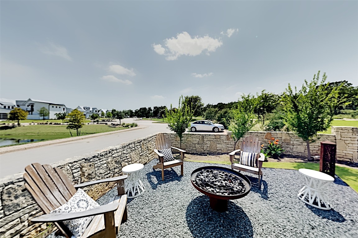 19517 Flying J Boulevard, Unit 6 Spicewood, TX 78669 - Photo 21 of 32 a view of a chairs and table in a patio