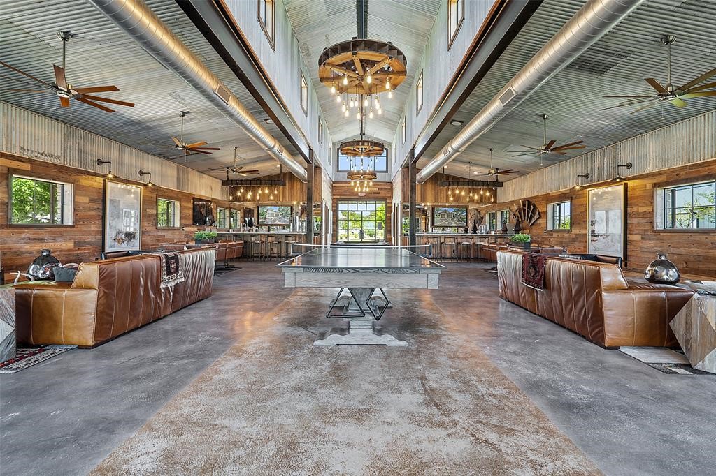 19517 Flying J Boulevard, Unit 6 Spicewood, TX 78669 - Photo 32 of 32 a living room with furniture and a chandelier