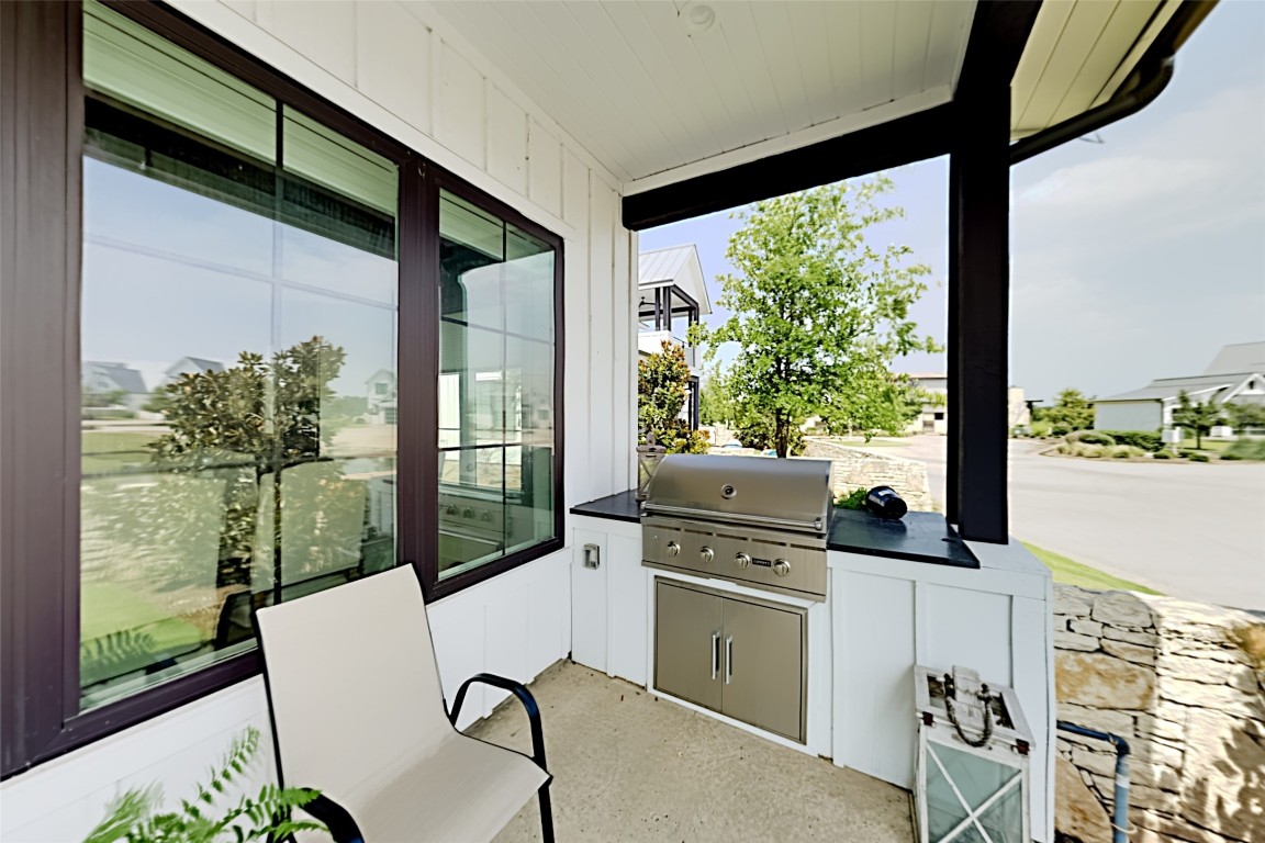 19517 Flying J Boulevard, Unit 6 Spicewood, TX 78669 - Photo 9 of 32 a view of a chairs and table in the balcony