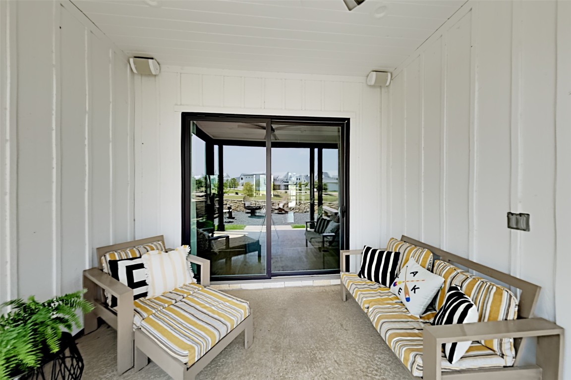19517 Flying J Boulevard, Unit 6 Spicewood, TX 78669 - Photo 10 of 32 a balcony with furniture and floor to ceiling window