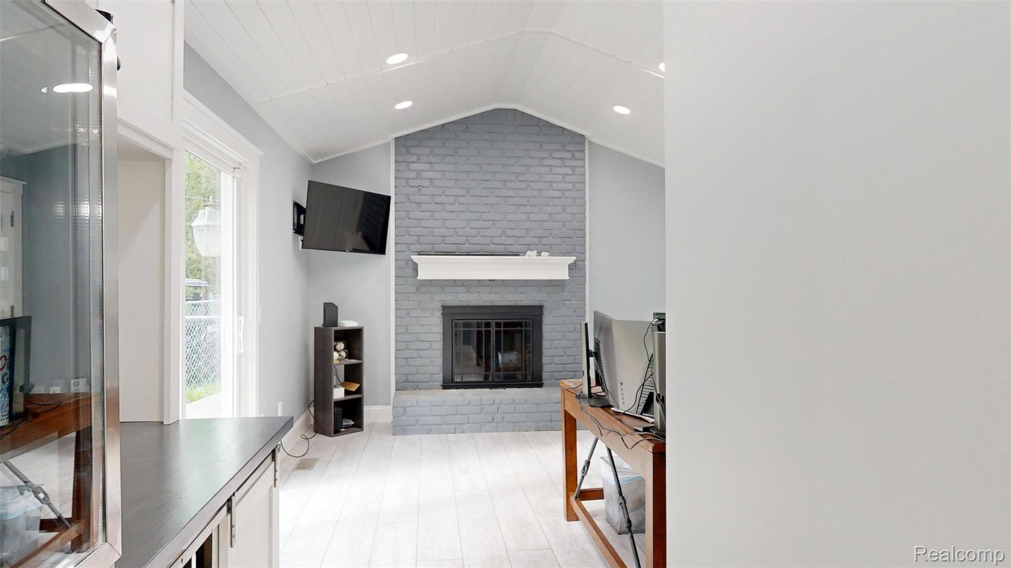 10300 Clark Road Davisburg, MI 48350 - Photo 11 of 39 Living area featuring a fireplace, recessed lighting, and light wood-style flooring