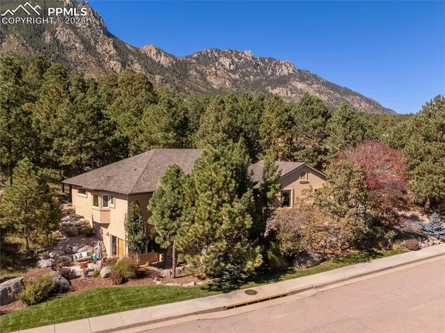 a view of a house with a yard and mountain