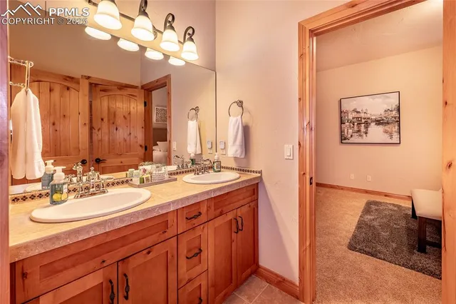 a bathroom with a double vanity sink and a mirror