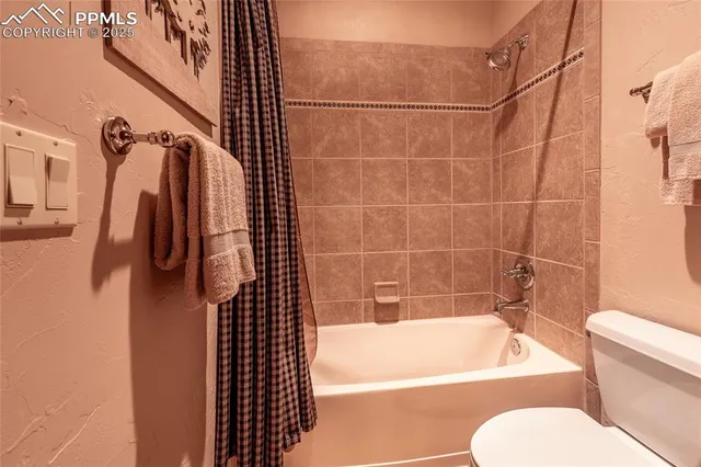 a bathroom with a toilet and a bathtub