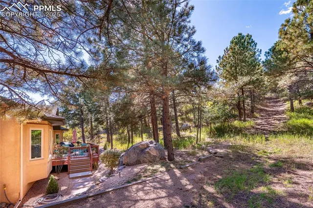 a backyard of a house with barbeque oven table and chairs