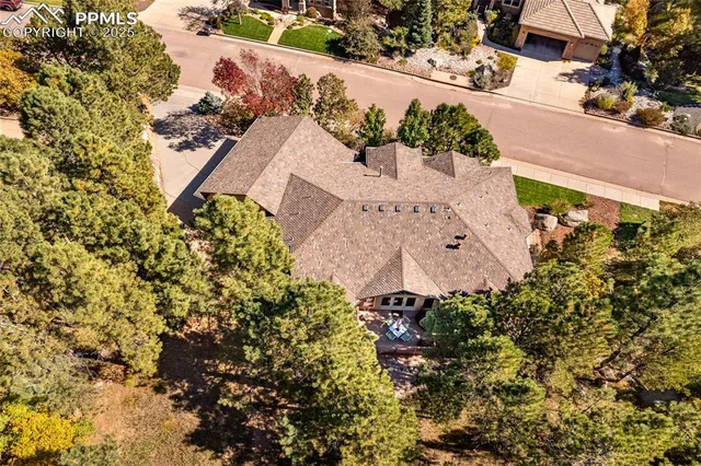 an aerial view of a house with a yard and garden
