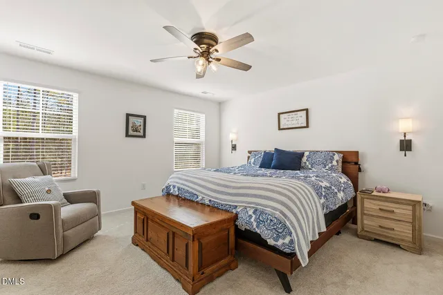 a living room with furniture a potted plant and a window